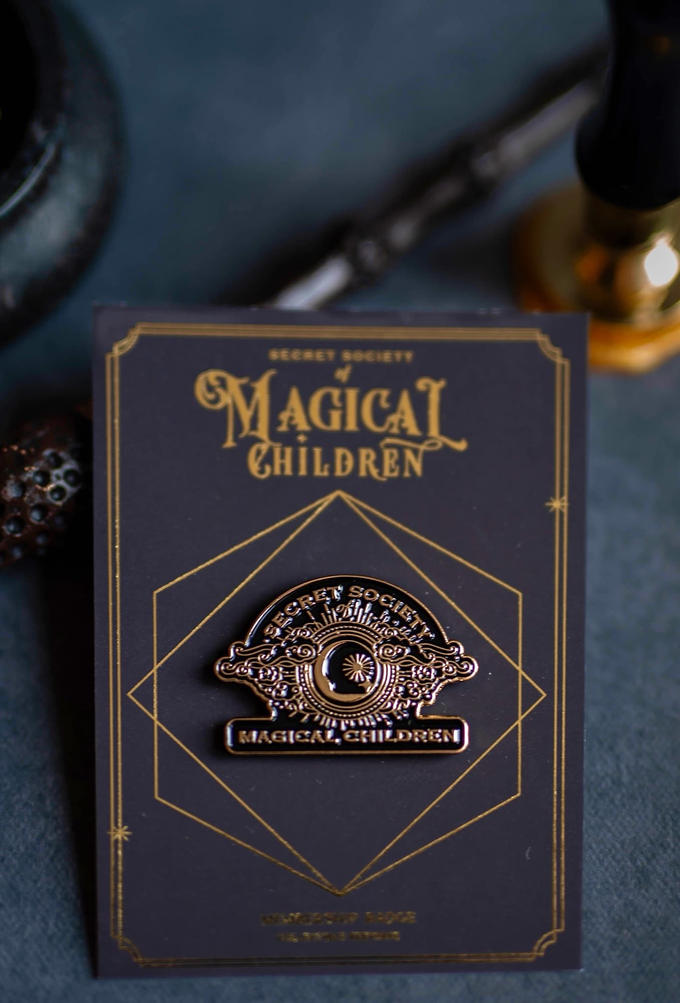 The membership pin badge on its card