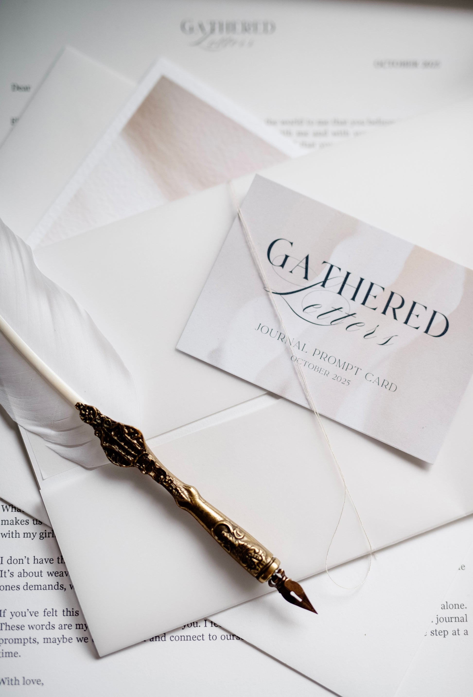 Gilded pen on a letter with 'Gathered Letters' stationery in the background